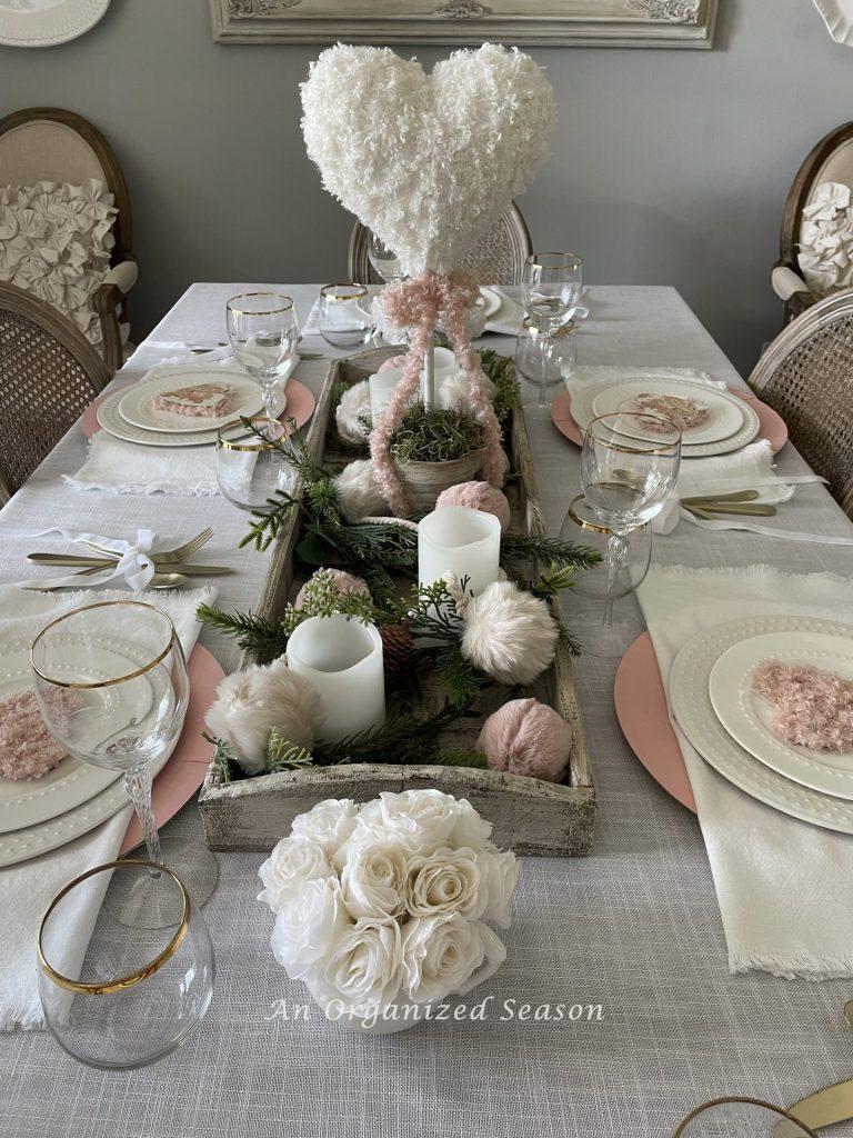An idea for a dining room table decorated and set for Galentine's Day.