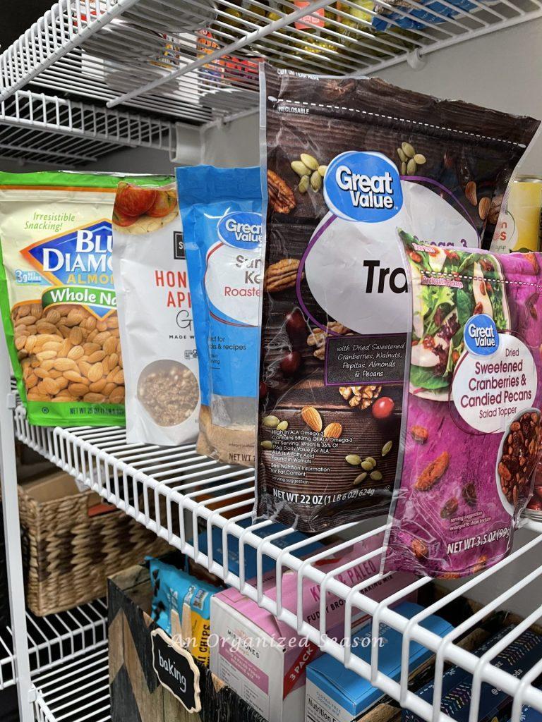 bags of snack food lined on a pantry shelf. 