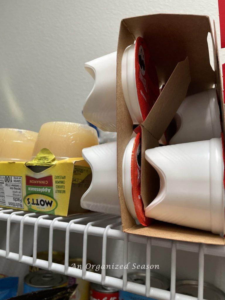 Individual chips and applesauce on a pantry shelf.