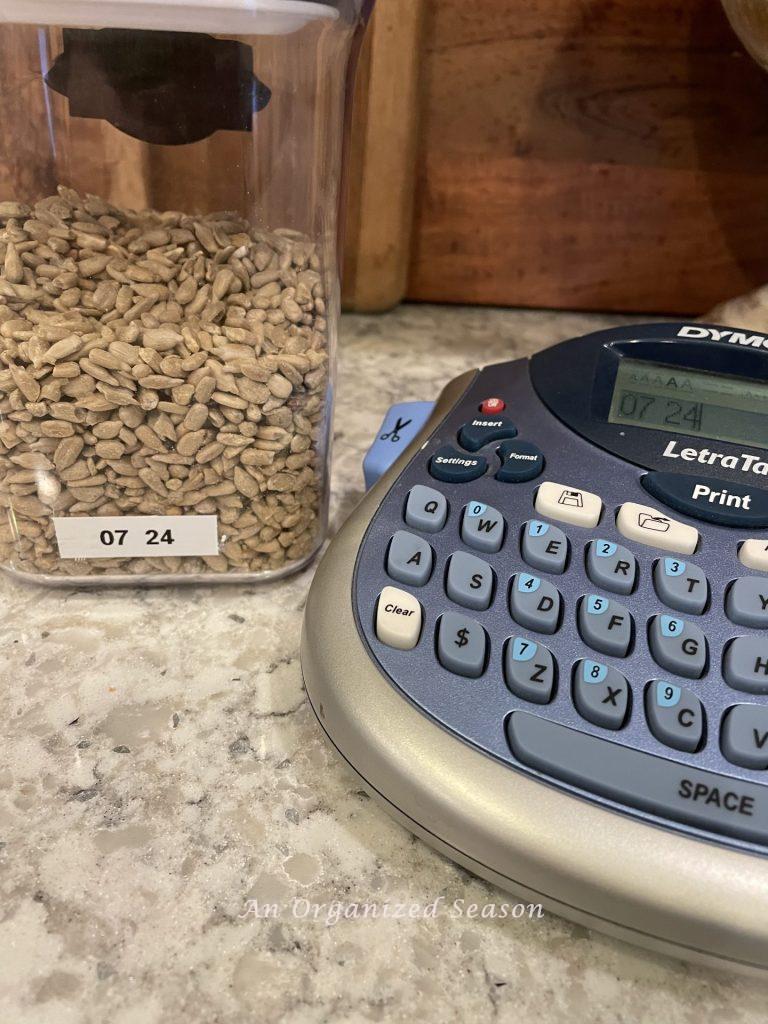 A container of sunflower seeds with a label of the expiration date. 