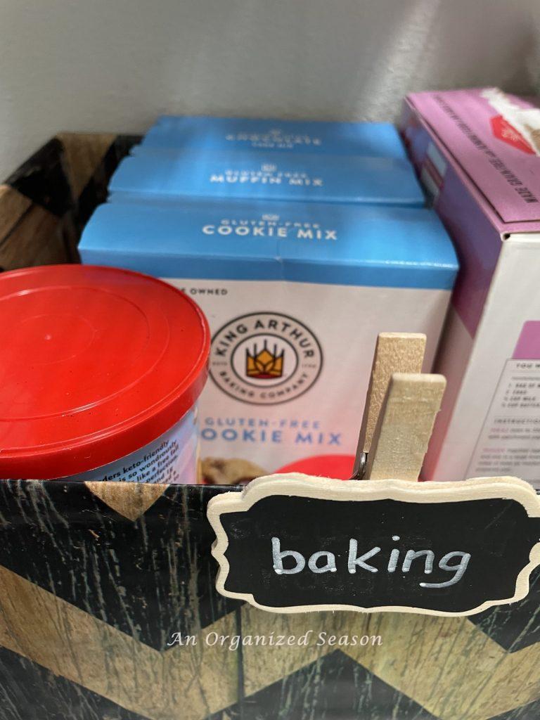 Baking mixes stored in a box in a pantry. 