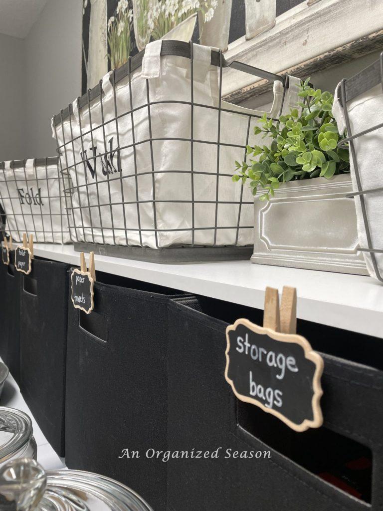 Use fabric storage cubes on top of the washer and dryer to hold back stock,  tip five to create an organized laundry room. 