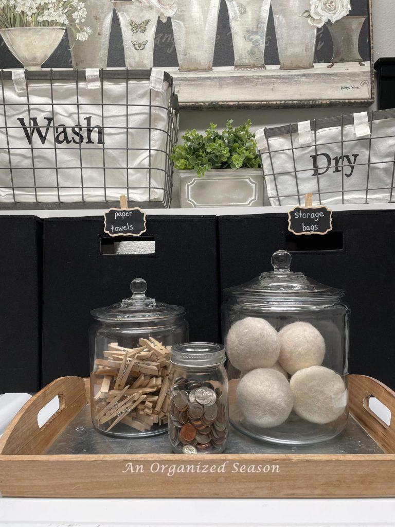 Store dryer balls, clothespins, and coins in glass jars on the dryer, tip four to create an organized laundry room. 
