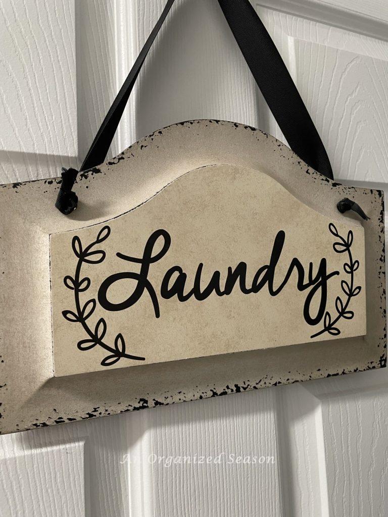 A sign that says "laundry" hanging on a door. 