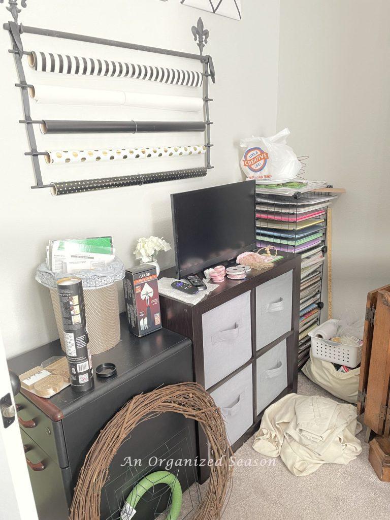 A messy craft room with items scattered around.