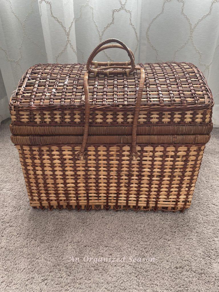 An old brown picnic basket. 