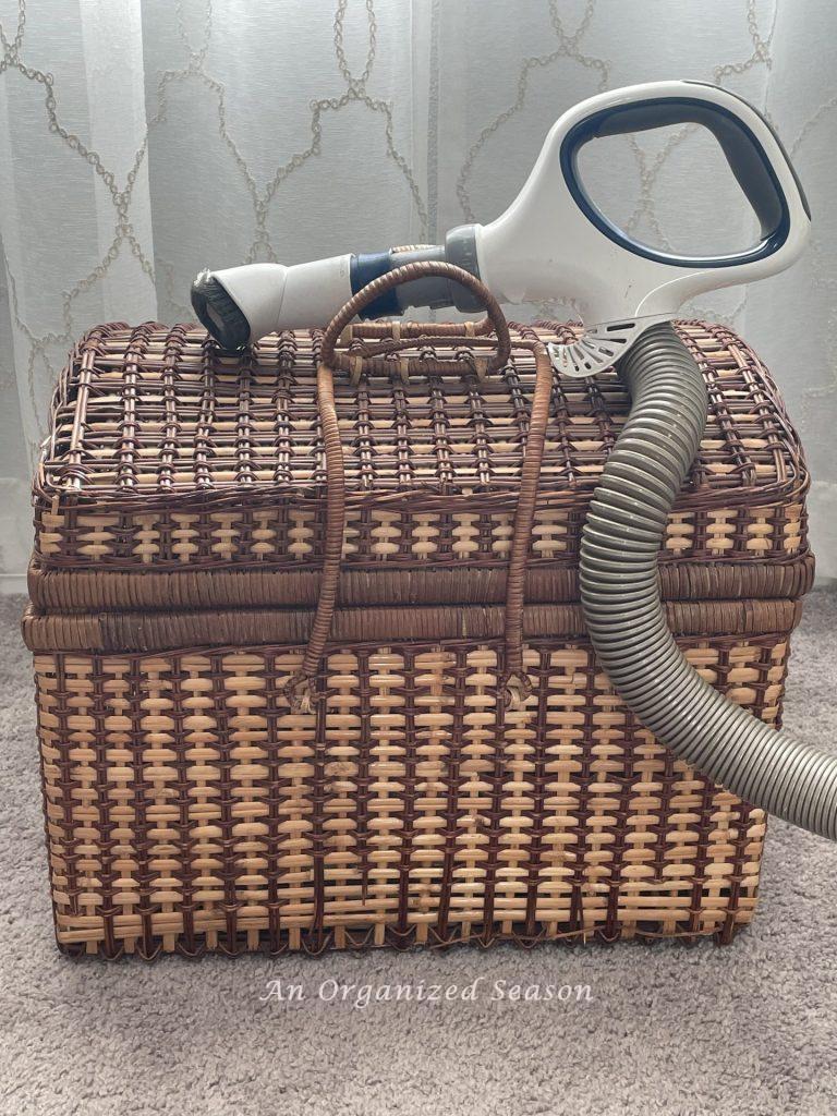 Step one to upcycle a picnic basket is to vacuum it clean.