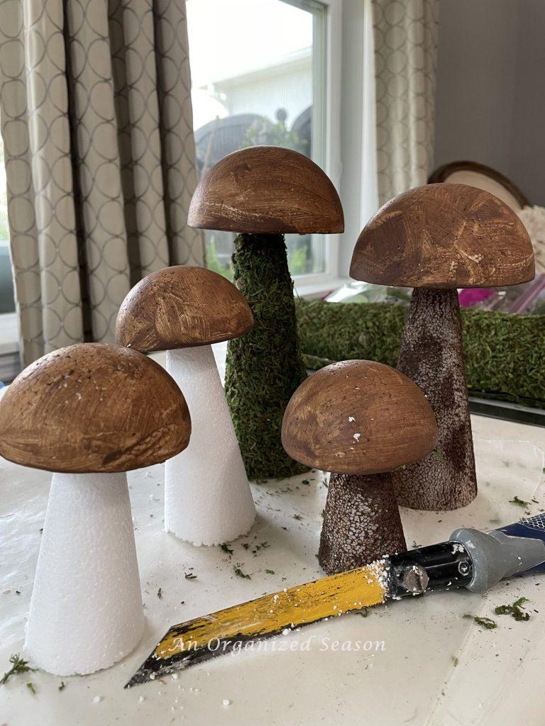Five mushrooms made from Styrofoam cones and half balls. 