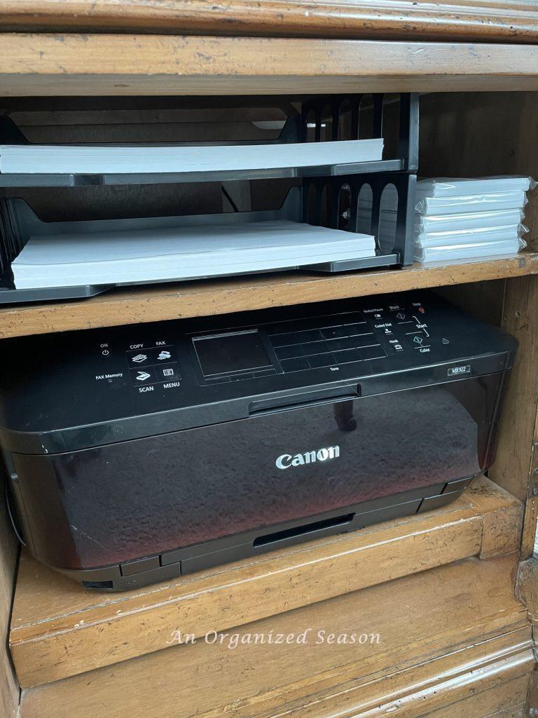 Storing all of your printing supplies next to your printer is a brilliant way to organize office supplies.