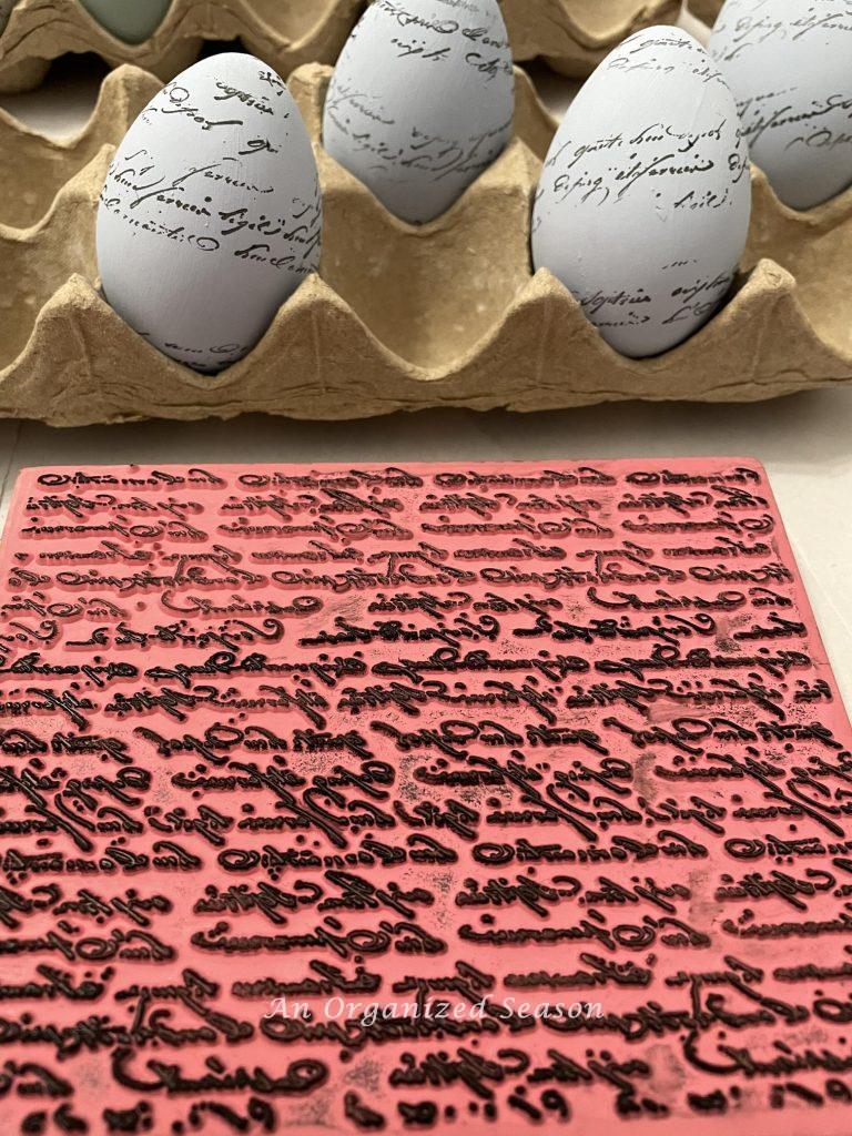 A script stamp and eggs that have been stamped with it.