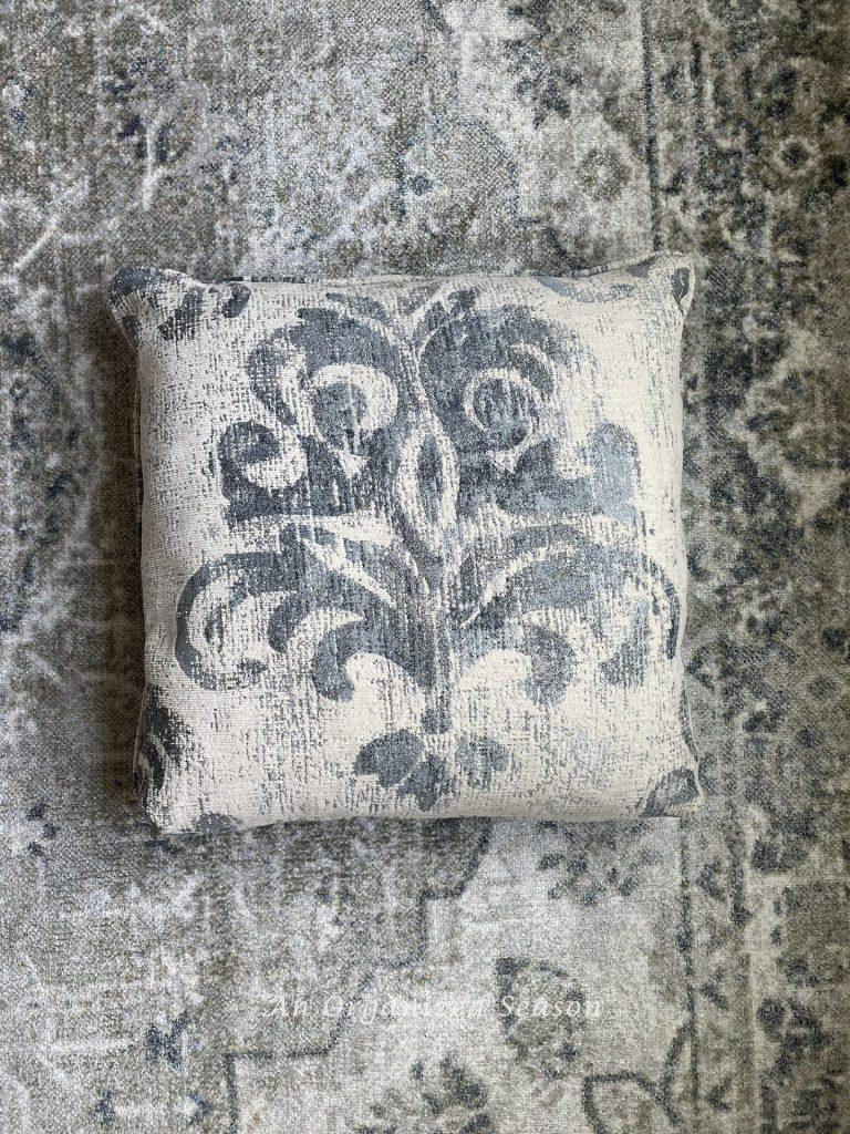 Choose a rug to go under your dining table that matches the decor in your home like this pillow! 