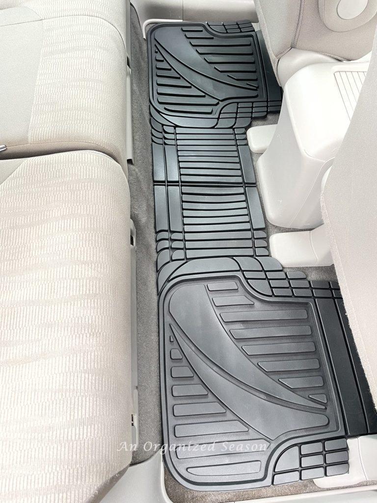 Floor mats in the back seat of an SUV. 