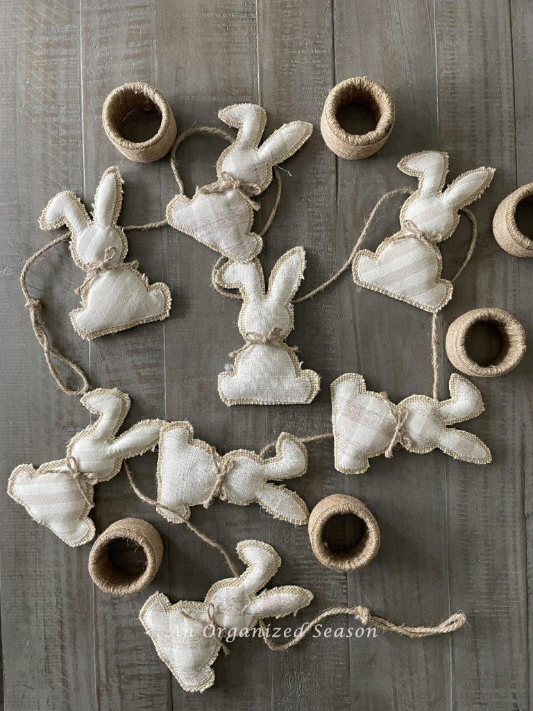 A bunny garland and six jute wrapped napkin rings.