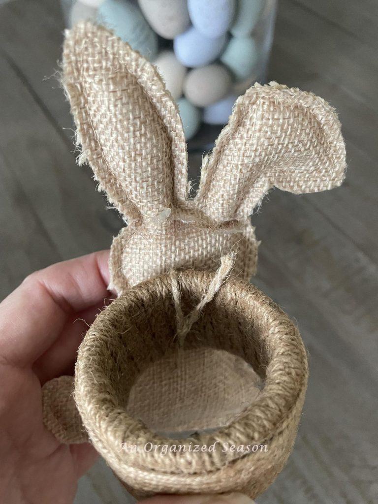 Tie a bunny to a napkin holder with jute twine for an easy Easter DIY.