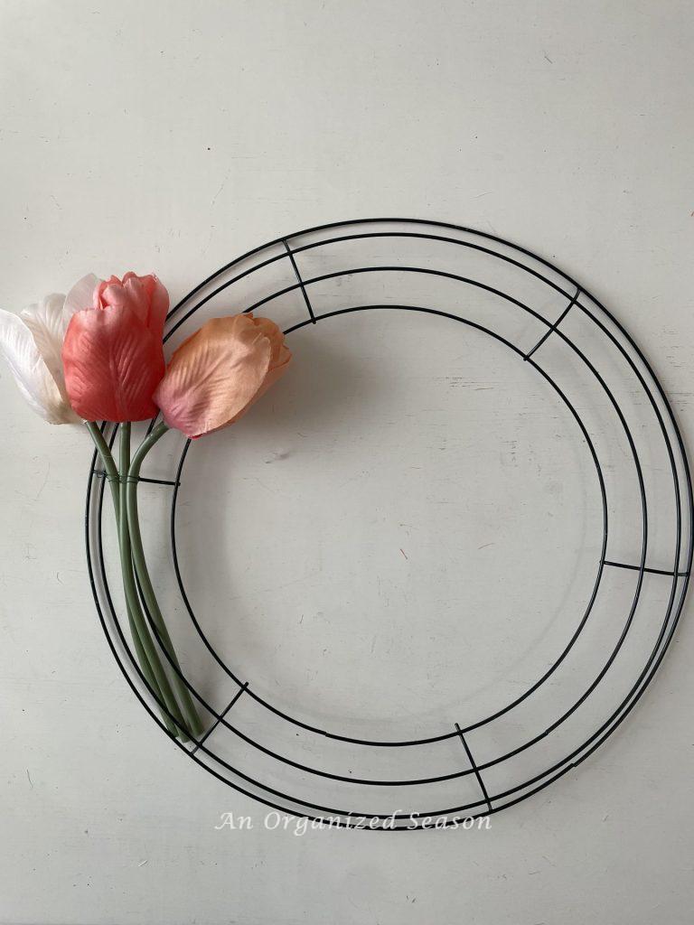 A set of three tulips wired to a wreath form. 