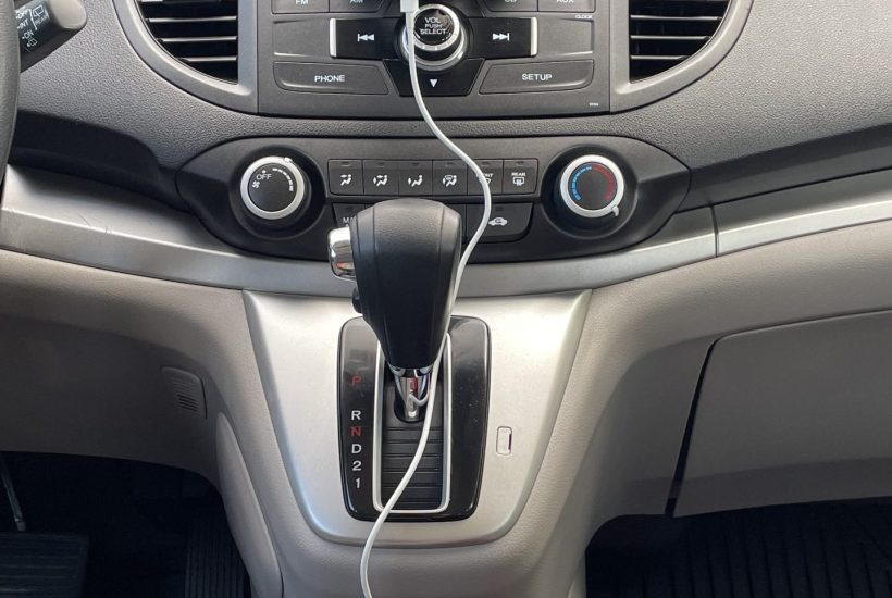 Hands free cell phone, charger, and cord in car.