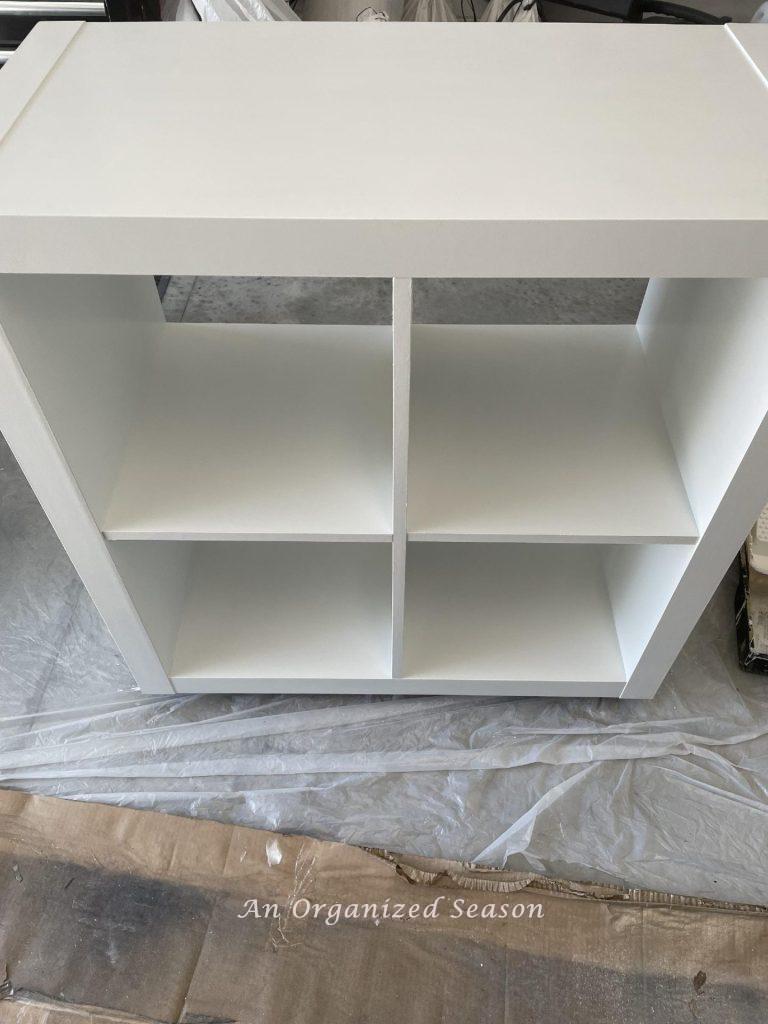 A laminate cabinet with two coats of white paint. 