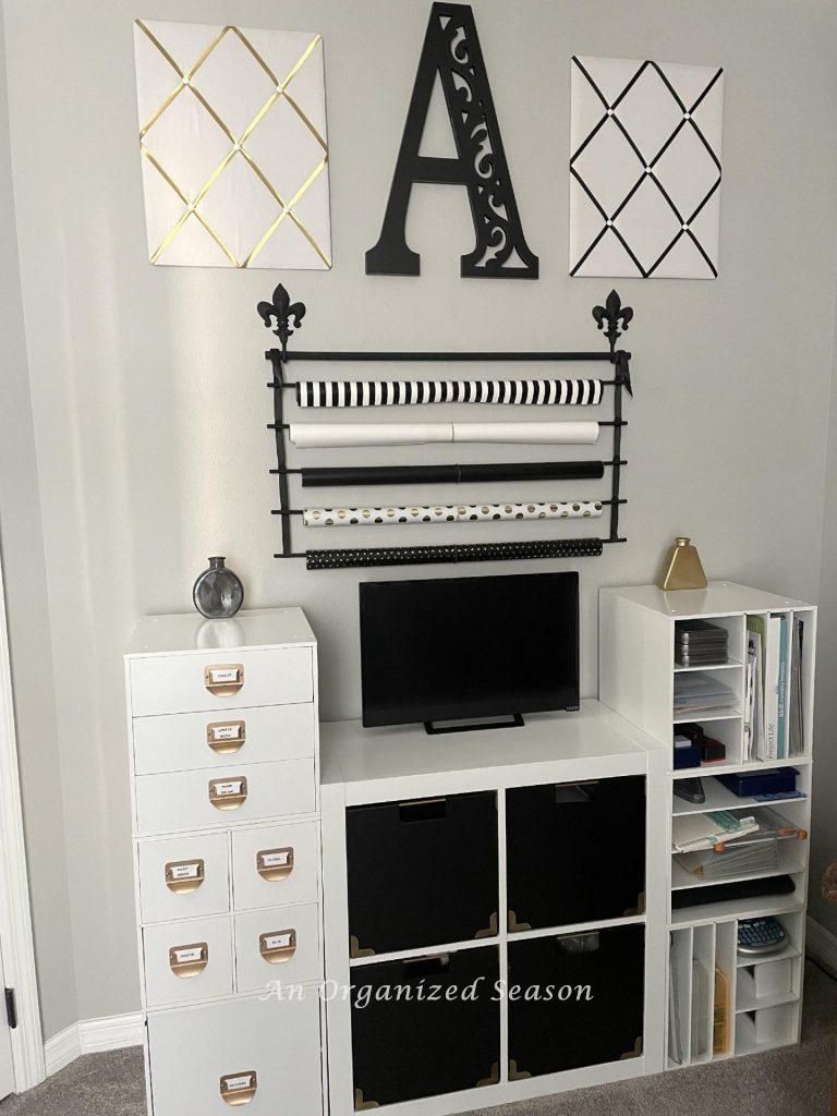 Storage cabinet with blacks cubes and white cube laminate storage on either side. 