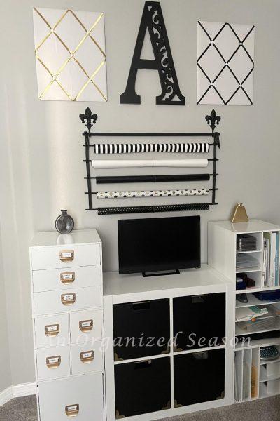 White laminate storage cabinets with black cubes and gold accents.