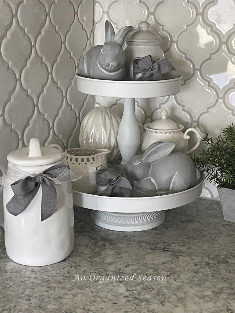 Add ceramic bunnies to a white tiered tray with white cream and sugar bowls for a great Spring decorating idea. 