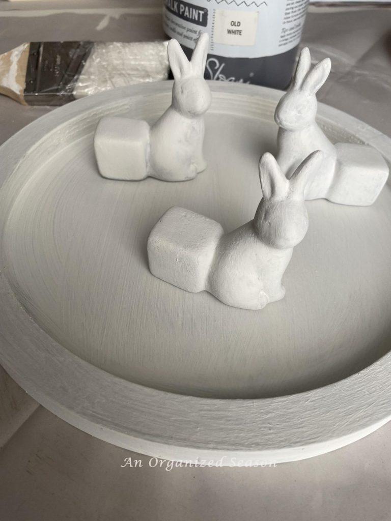 Paint a wood tray and three bunny figures white to make a DIY tray. 