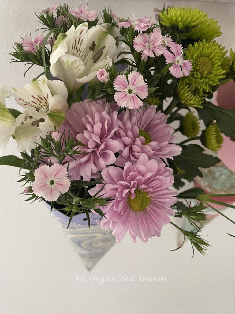 Flowers inside a paper basket.