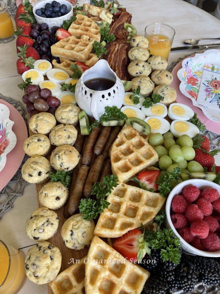 Breakfast food arranged on a large cutting board. 