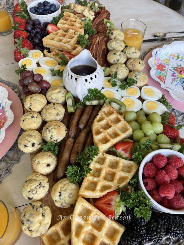 Breakfast food arranged on a large cutting board.