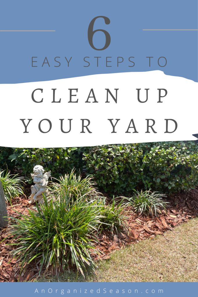 A maintained plant bed with shrubs, liriope, and an angel statue.