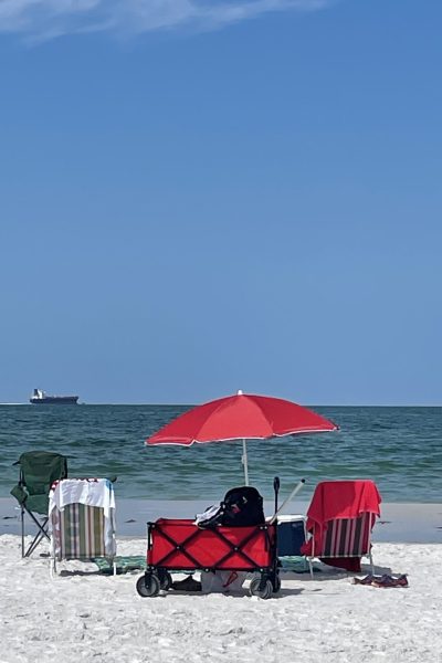 Chairs and umbrella set up on a beach.