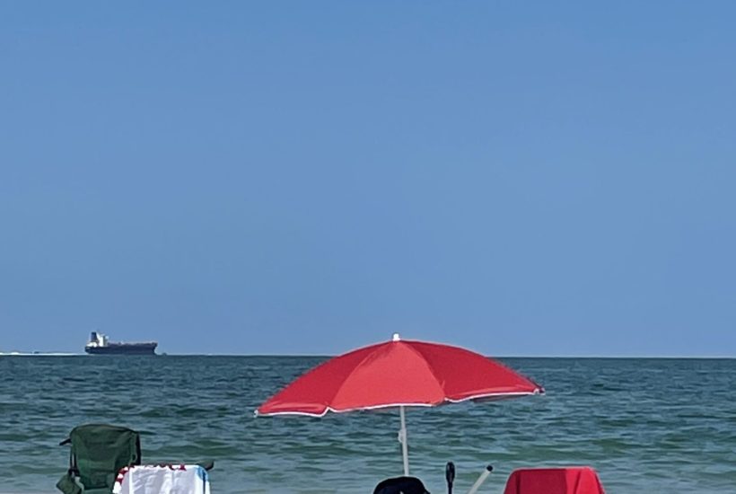 Chairs and umbrella set up on a beach.