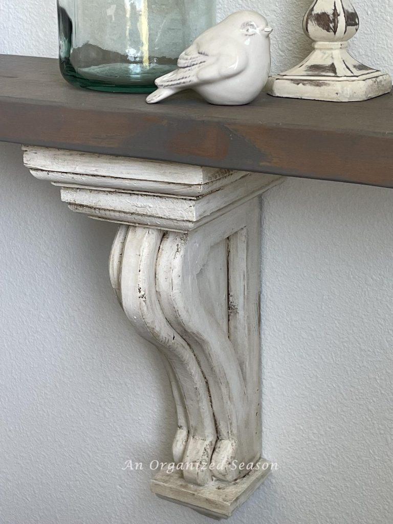 A decorative corbel holding up a shelf. 