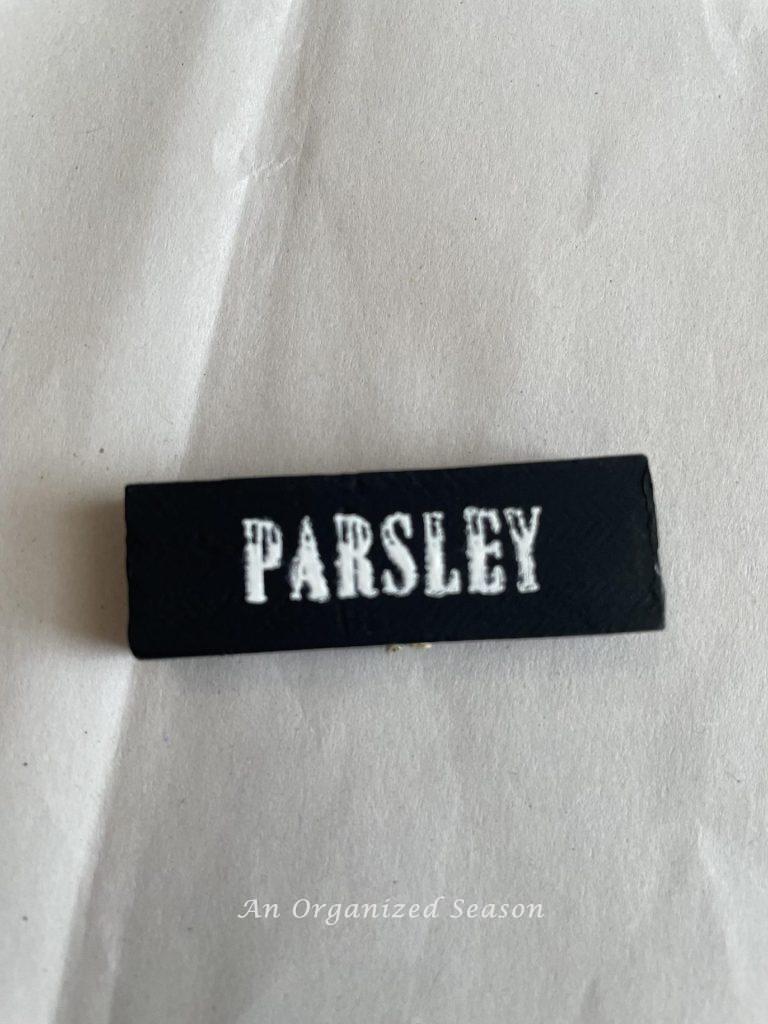 A black block with the word "parsley" painted on it. 
