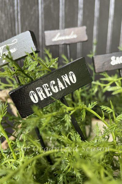 Black and white garden markers with herb names