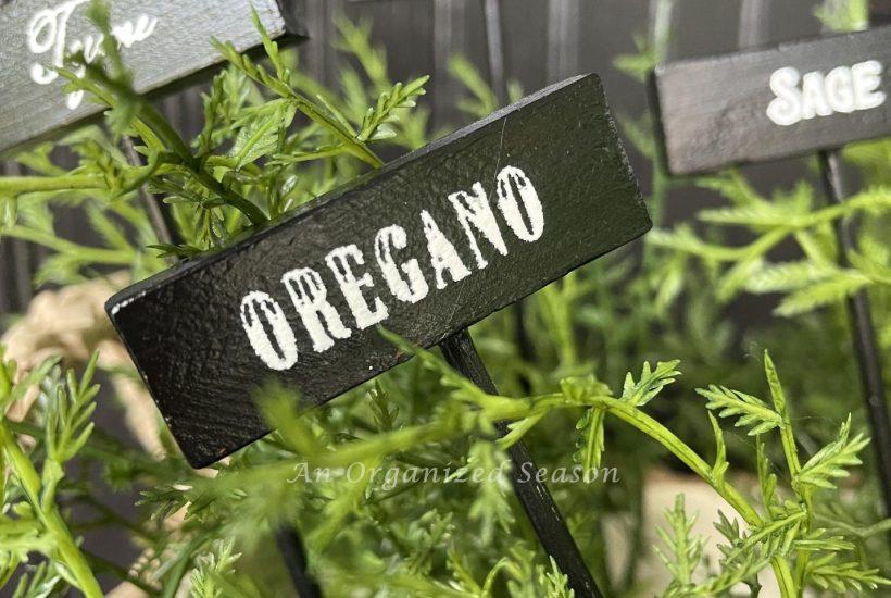 Black and white garden markers with herb names