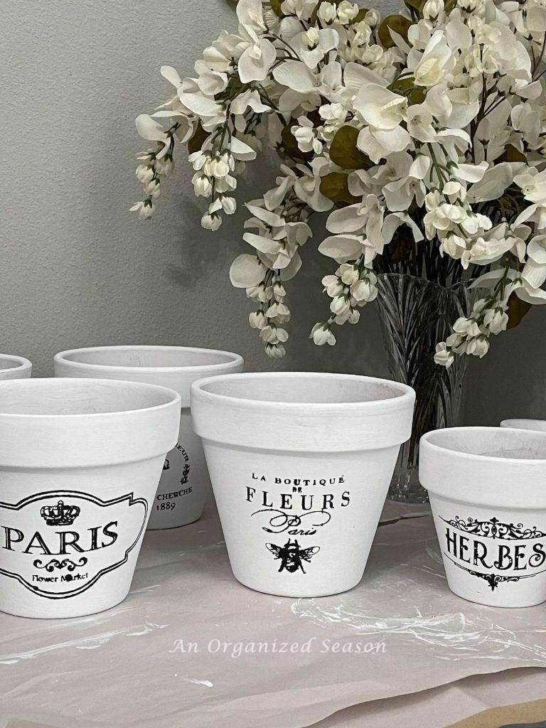 Step two to paint flower pots is to stencil them with black paint. 