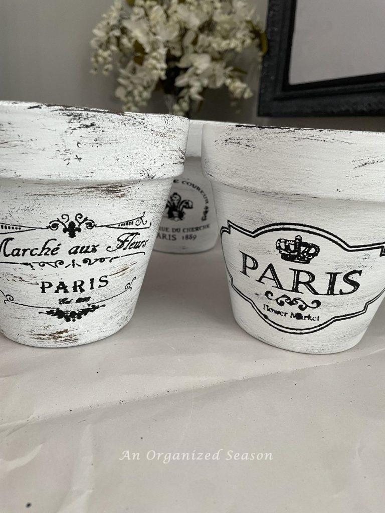 Step four to paint flower pots is to distress them more with brown paint.