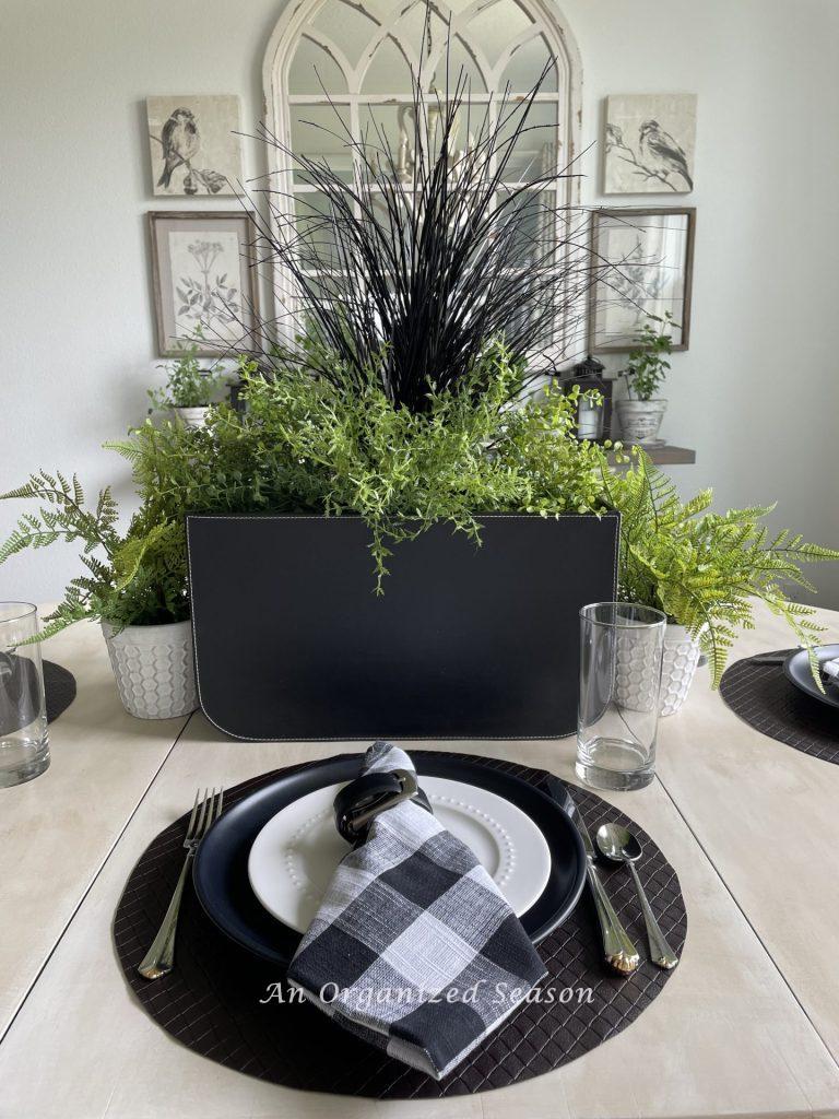 A centerpiece and place setting on a table. 