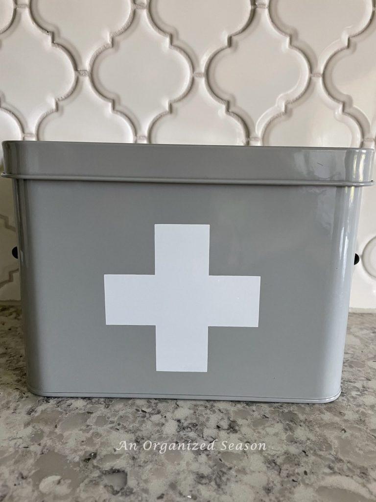 Gray metal container with a white cross on it. 