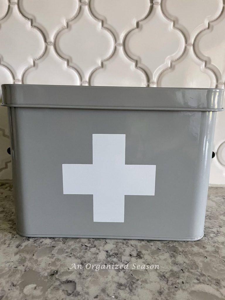 Gray metal container with a white cross on it.