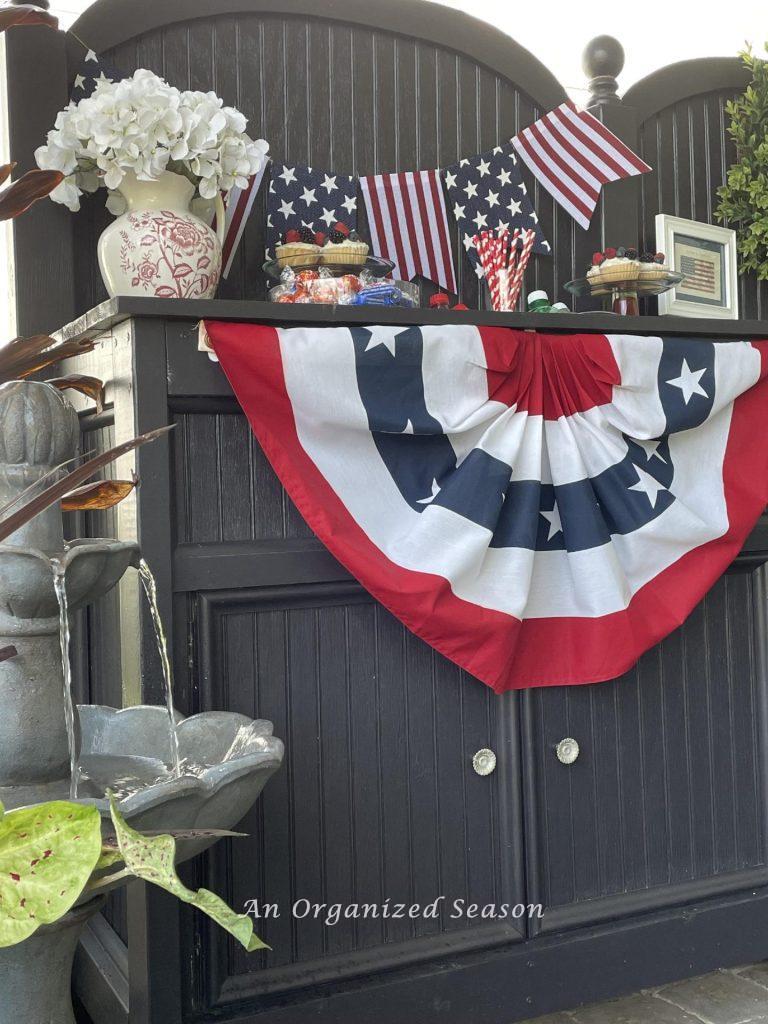 Patriotic idea number one is to hang a bunting on a potting bench.