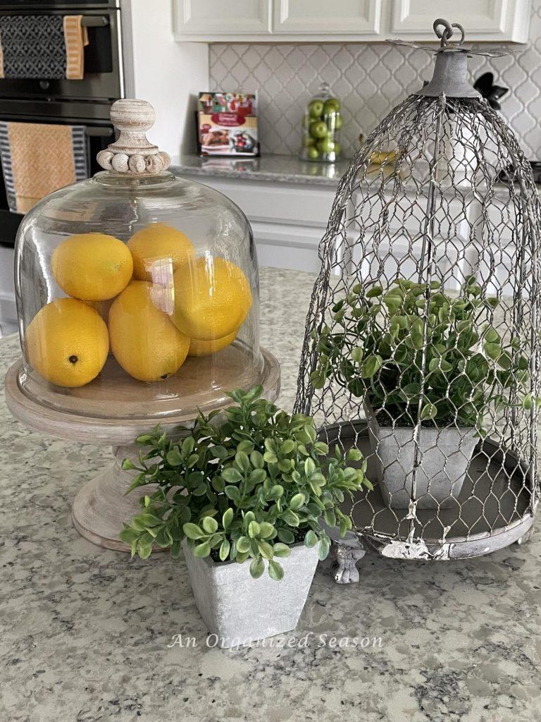 Summer decor tip #3, display lemons on a small wood cake plate on a kitchen counter. 
