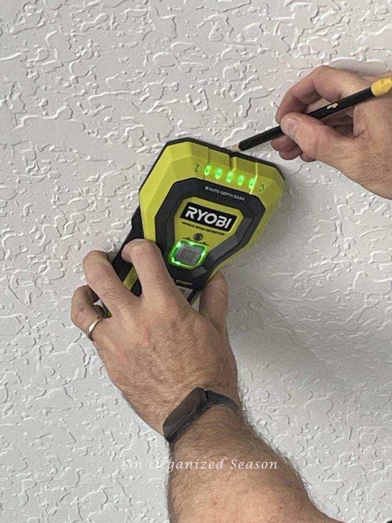  Step one to install overheard garage storage is marking ceiling with a stud finder.