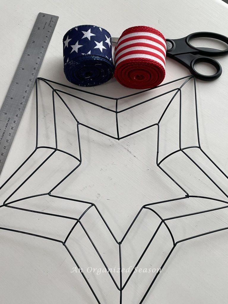 Gather a star wreath form, patriotic ribbon, scissors, and a ruler to make a DIY 4th of July wreath. 