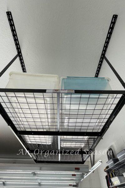 Black metal overhead storage rack hanging in garage