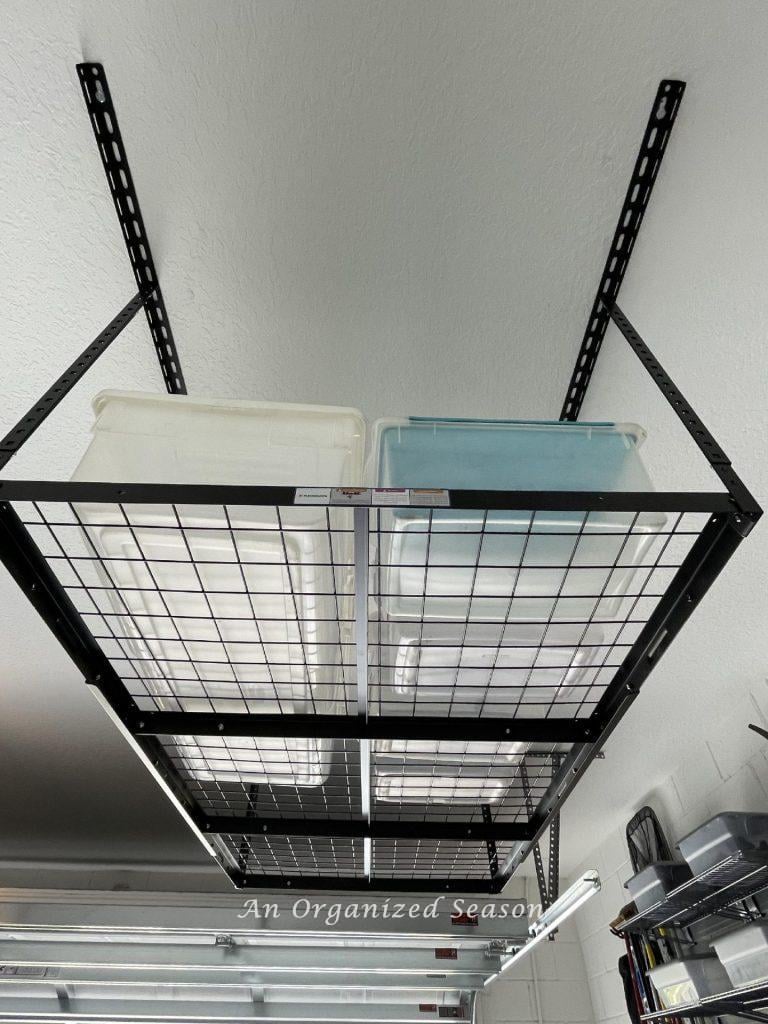 Black overhead garage storage hanging on a garage ceiling.