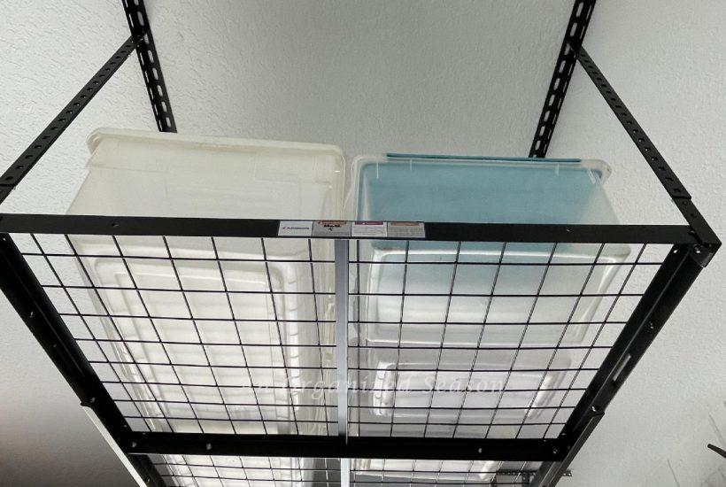 Black metal overhead storage rack hanging in garage