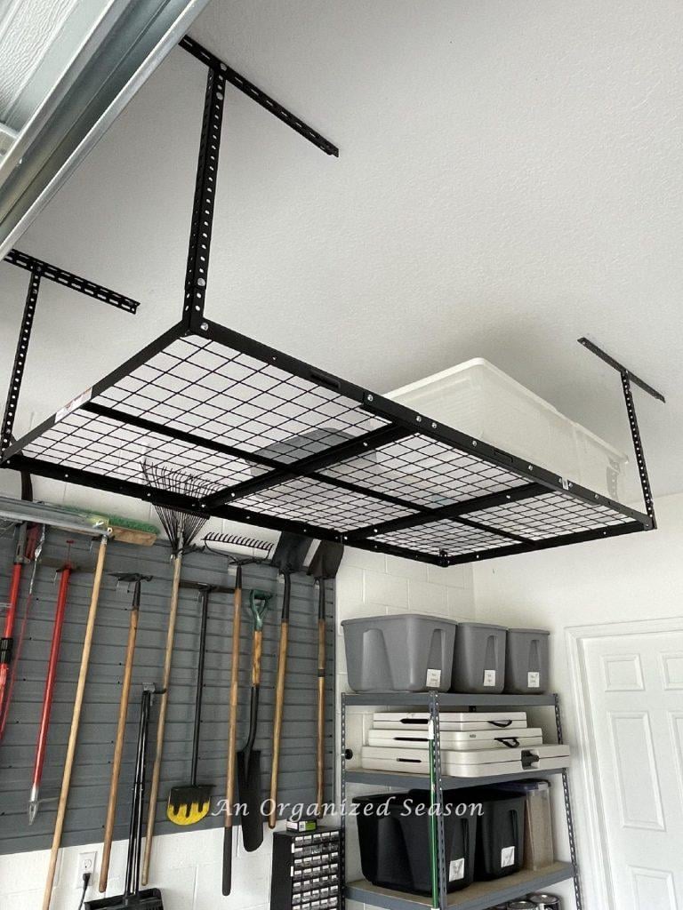 Overhead garage storage unit hanging in a garage.