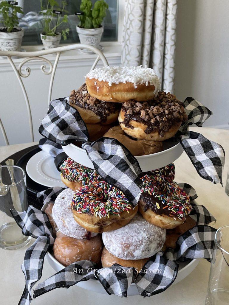 Donuts stacked on a tiered tray. 