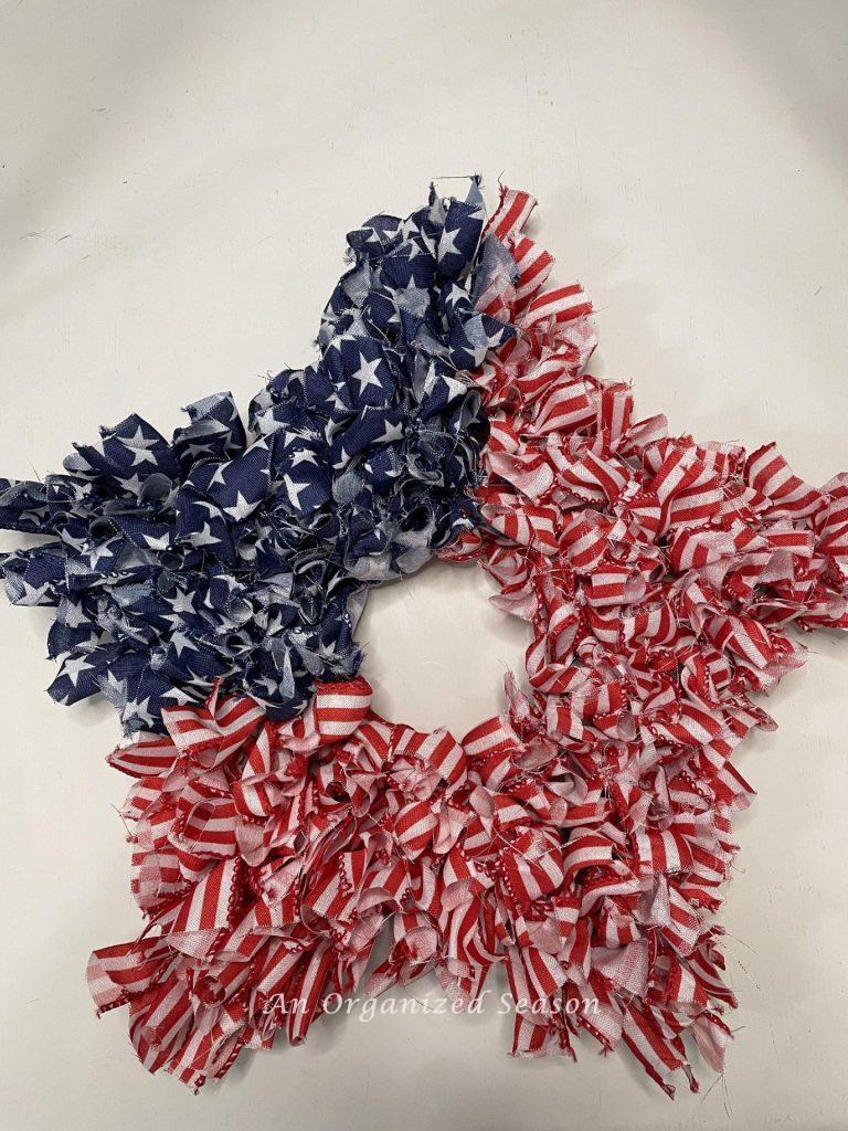 A 4th of July star ribbon wreath that looks like an American flag. 